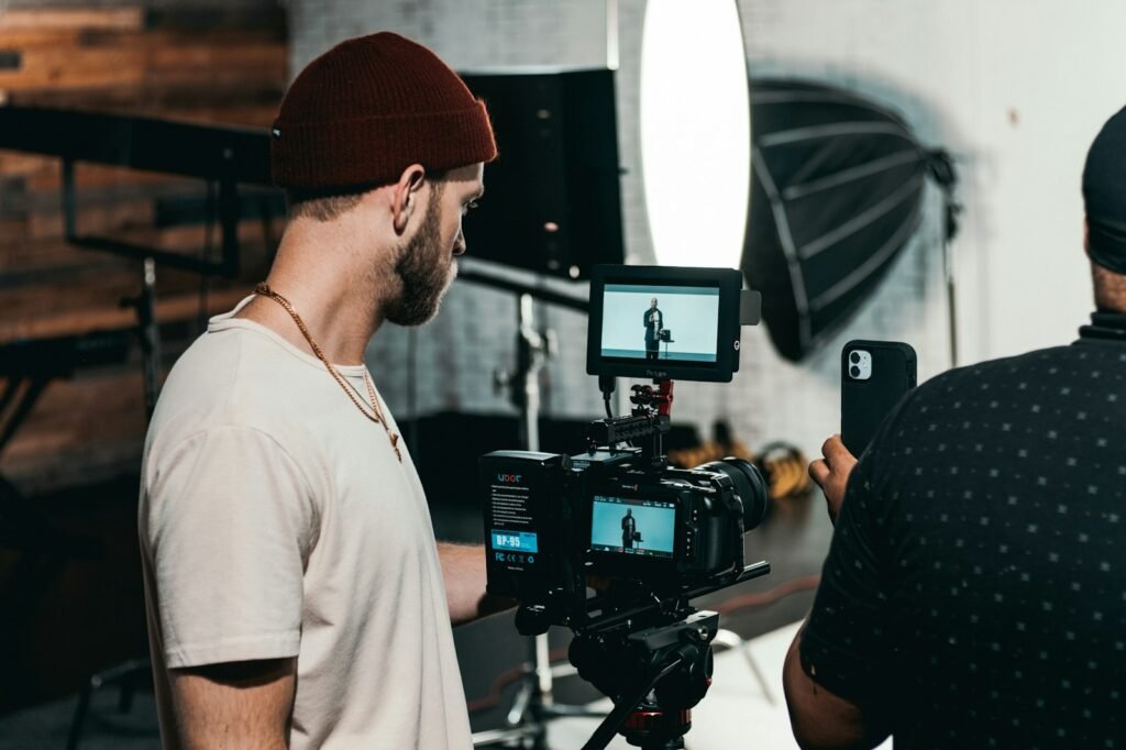 Two creators setting up a camera in a studio